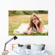 Romantic girl writing in a diary lying down outdoors Wall Mural