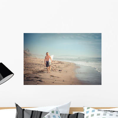 Man Surfer Walking along Wall Decal shown on a wall