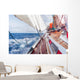 sail boat navigating on the waves Wall Mural