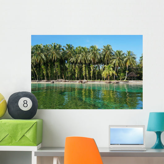 Coconut trees with epiphytes and hut on sea shore Wall Mural
