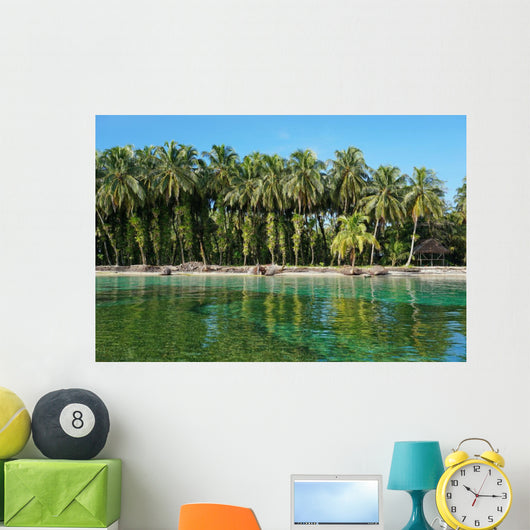 Coconut trees with epiphytes and hut on sea shore Wall Mural