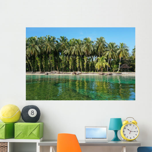 Coconut trees with epiphytes and hut on sea shore Wall Mural