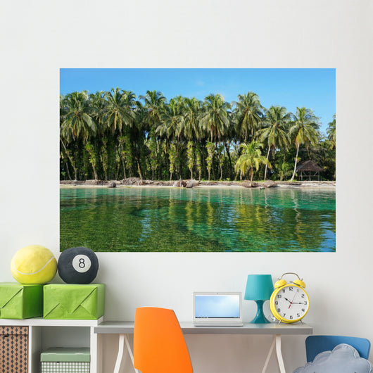 Coconut trees with epiphytes and hut on sea shore Wall Mural
