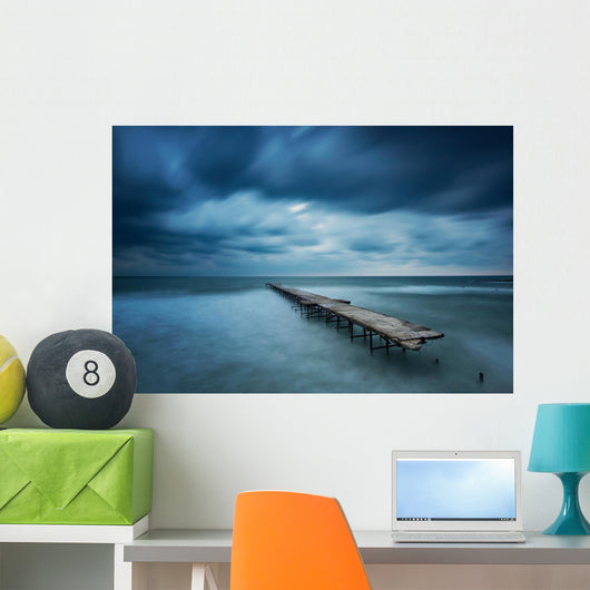 Winter landscape with old broken bridge among the stormy sea Wall Mural