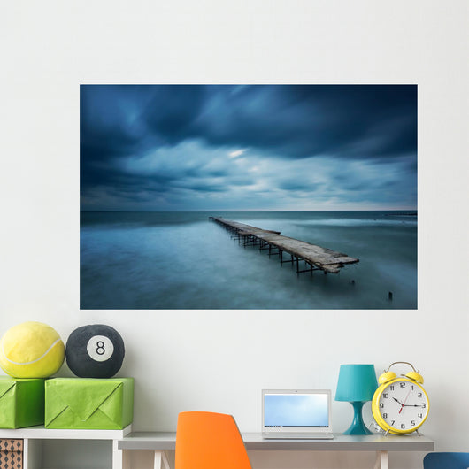 Winter landscape with old broken bridge among the stormy sea Wall Mural