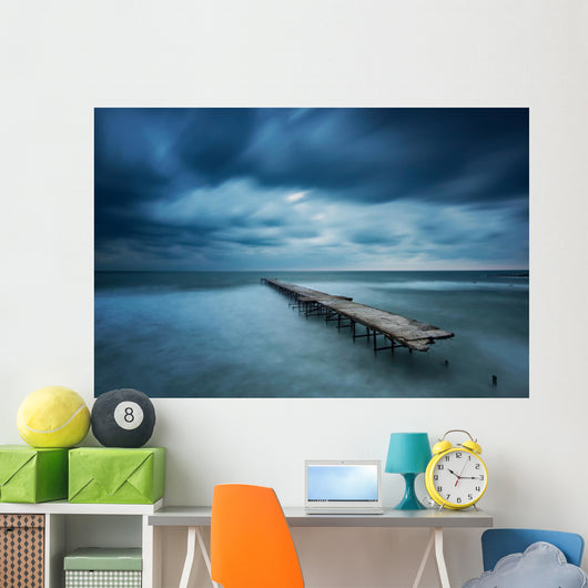 Winter landscape with old broken bridge among the stormy sea Wall Mural