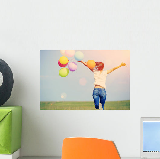 young asian woman on green grassland with colored balloons  Wall Decal