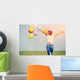 young asian woman on green grassland with colored balloons  Wall Decal