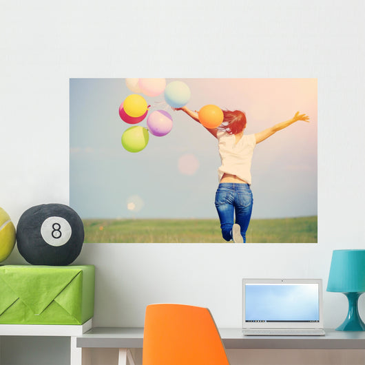 young asian woman on green grassland with colored balloons  Wall Decal