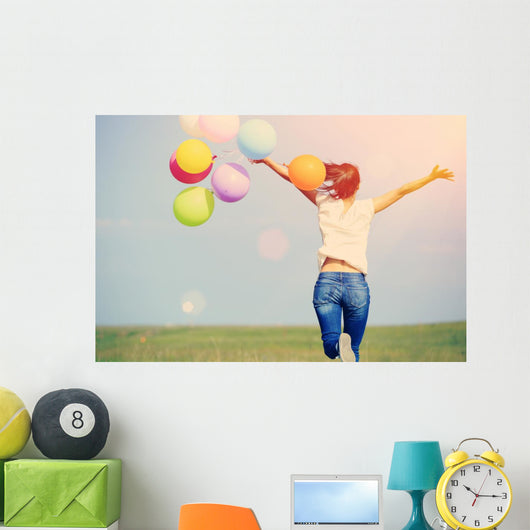 young asian woman on green grassland with colored balloons  Wall Decal