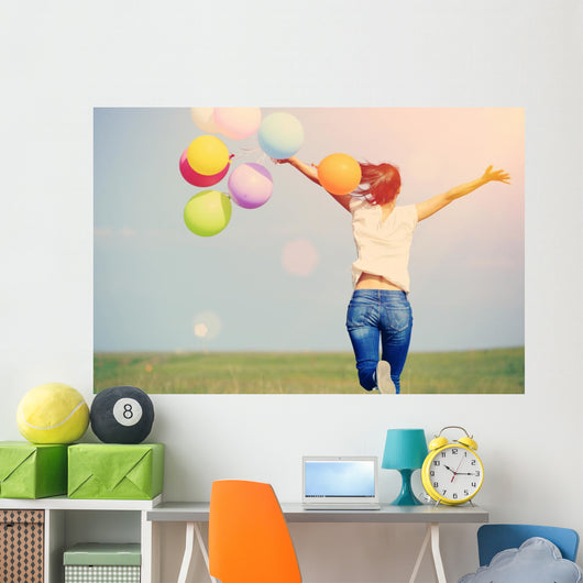 young asian woman on green grassland with colored balloons  Wall Decal