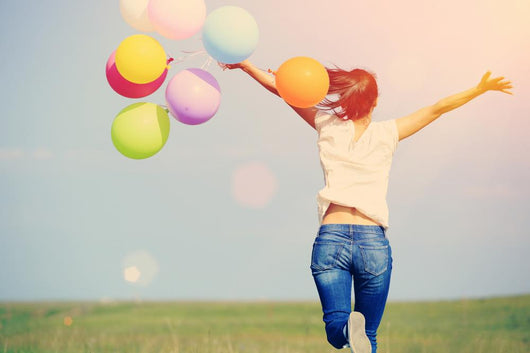 young asian woman on green grassland with colored balloons  Wall Decal
