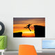 Man jumping across the gap from one rock to cling to the other. Wall Decal
