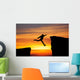 Man jumping across the gap from one rock to cling to the other. Wall Decal