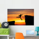 Man jumping across the gap from one rock to cling to the other. Wall Decal