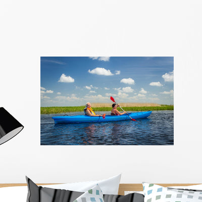 Couple Kayaking On River Wall Decal shown on a wall