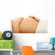 Pregnant woman massagin her belly Wall Decal