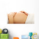 Pregnant woman massagin her belly Wall Decal