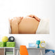 Pregnant woman massagin her belly Wall Decal
