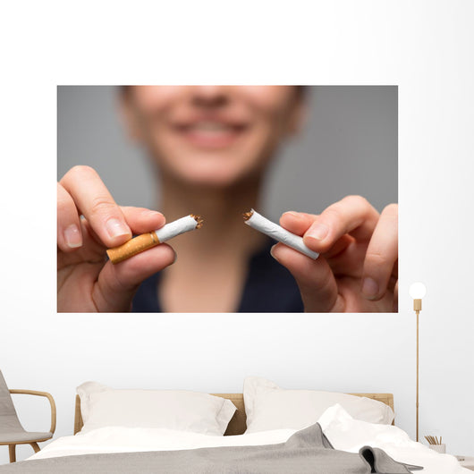 Addiction. Closeup of young attractive woman breaking cigarettes Wall Decal