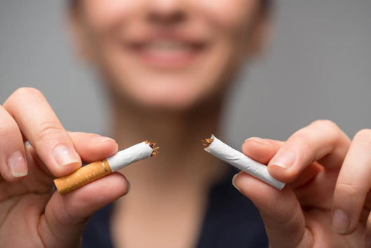 Addiction. Closeup of young attractive woman breaking cigarettes Wall Decal