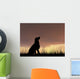Dog silhouette in grass at sunset Wall Decal