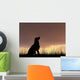 Dog silhouette in grass at sunset Wall Decal