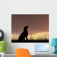 Dog silhouette in grass at sunset Wall Decal