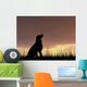 Dog silhouette in grass at sunset Wall Decal