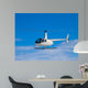 Helicopter flying in the blue sky Wall Decal