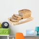 Cut wholemeal bread on a chopping board Wall Decal