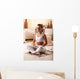 Young woman meditate in her living room. Wall Decal