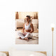Young woman meditate in her living room. Wall Decal