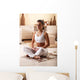 Young woman meditate in her living room. Wall Decal