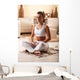 Young woman meditate in her living room. Wall Decal
