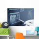Gloved hand holding dental tool to teeth x-ray Wall Decal