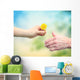 Young woman giving a dandelion to senior woman Wall Decal