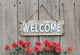 Welcome sign with row of mums by wood fence Wall Decal