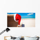 Red santa hat on chair longue at tropical caribbean beach Wall Decal