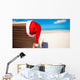 Red santa hat on chair longue at tropical caribbean beach Wall Decal