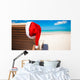 Red santa hat on chair longue at tropical caribbean beach Wall Decal
