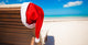 Red santa hat on chair longue at tropical caribbean beach Wall Decal