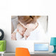 Young mother breastfeeding the newborm baby - indoors Wall Decal