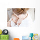 Young mother breastfeeding the newborm baby - indoors Wall Decal