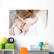 Young mother breastfeeding the newborm baby - indoors Wall Decal