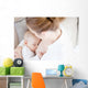 Young mother breastfeeding the newborm baby - indoors Wall Decal