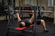 young man doing bench press workout in gym Wall Decal