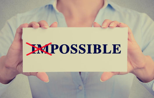 woman hands card crossed off first two letters word impossible Wall Decal