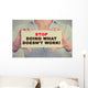 Businesswoman hands holding sign Stop Doing What Doesn't Work Wall Decal