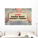 Businesswoman hands holding sign Stop Doing What Doesn't Work Wall Decal